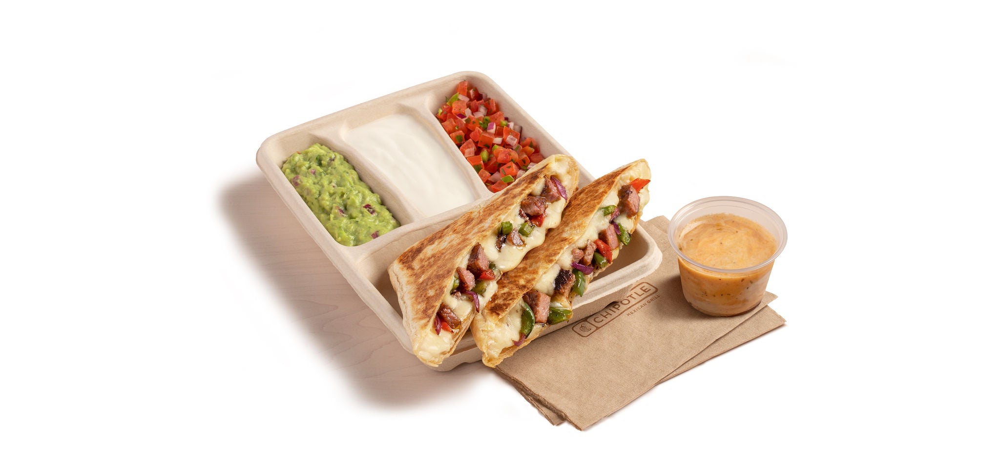 A Carne Asada Fajita Quesadilla with a side of hand-mashed Guacamole, Sour Cream, Fresh Tomato Salsa, and Chipotle Vinaigrette.