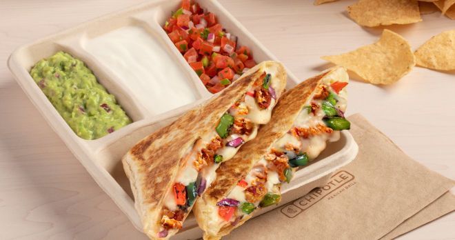 A plant-based Sofritas Fajita Quesadilla with a side of hand-mashed Guac, Sour Cream, and Fresh Tomato Salsa.